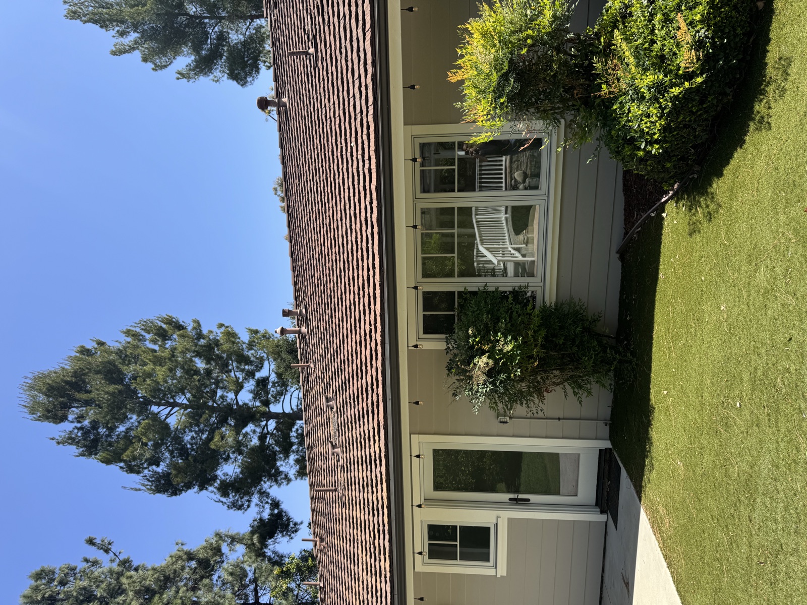 Custom clay-tile roof with copper vents and clean ridge line on a Los Angeles residential build — PBG.