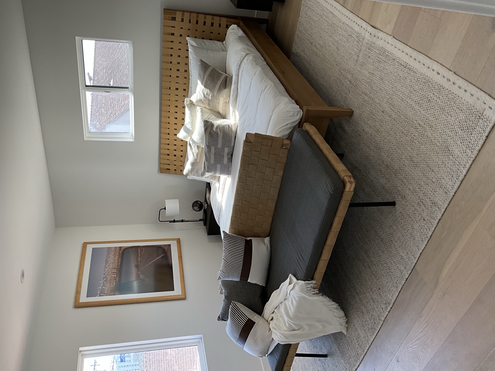 Staged bedroom with deck slider and view — custom residential by PBG, Los Angeles.