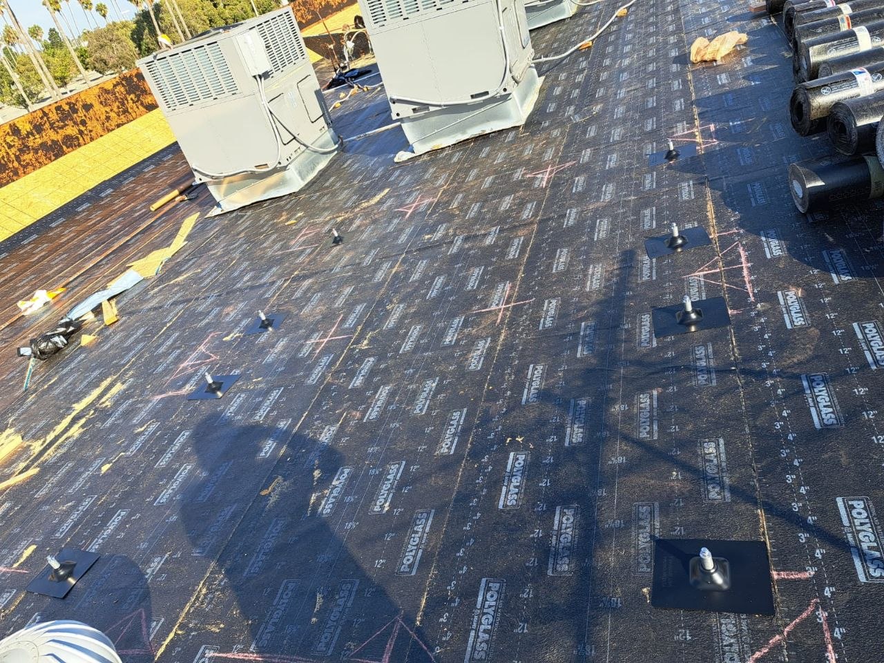 Polyglass modified-bitumen roof system with rooftop HVAC integration — PBG roofing work.