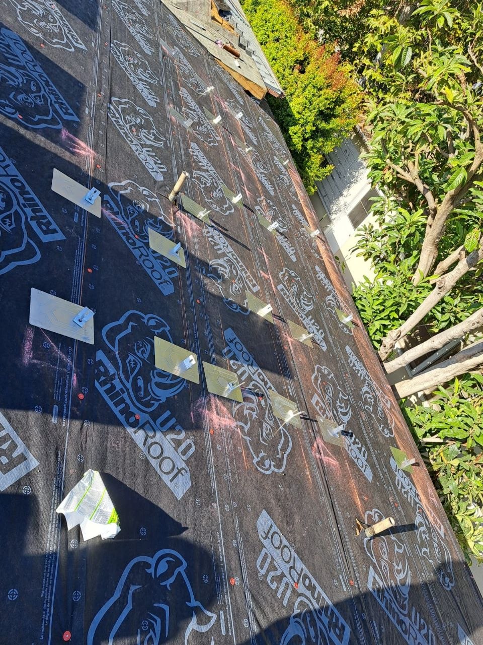 Wide angled view of RhinoRoof U20 underlayment with blue tile clips set in precision rows along chalk lines — PBG residential re-roof, Los Angeles.