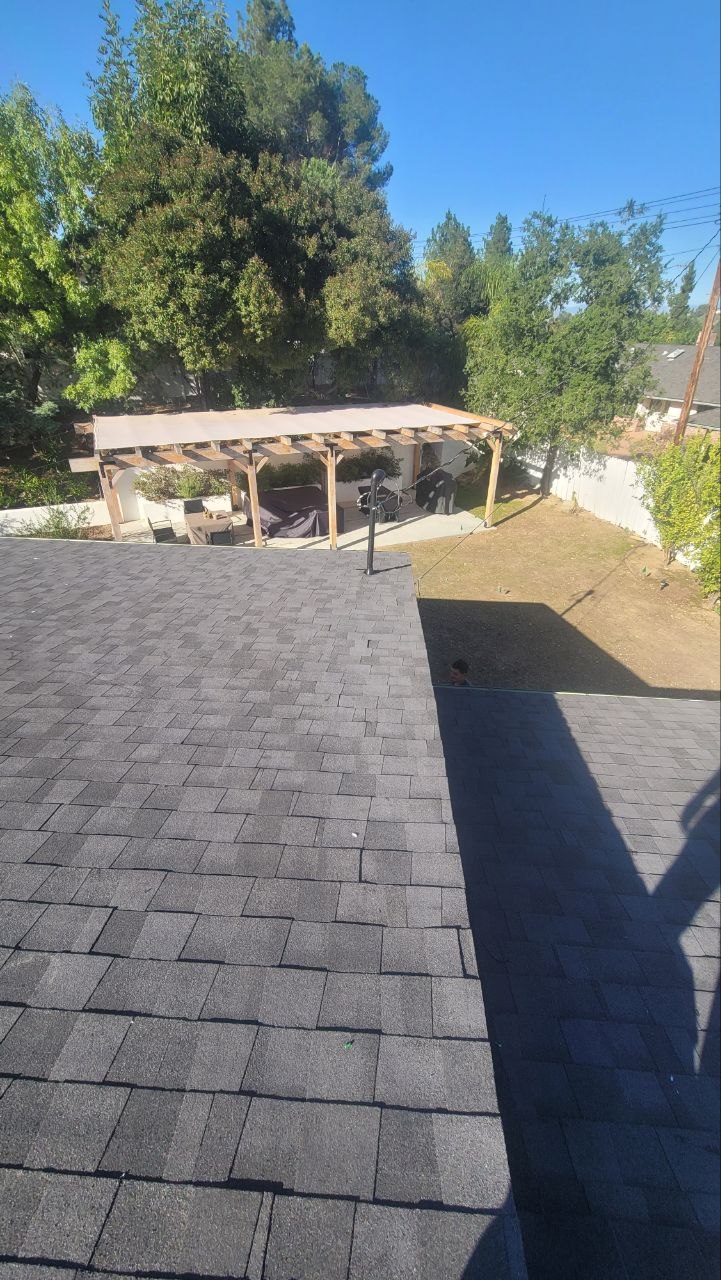 Residential shingle roof with backyard pergola — solar-integrated build context by PBG, Los Angeles.