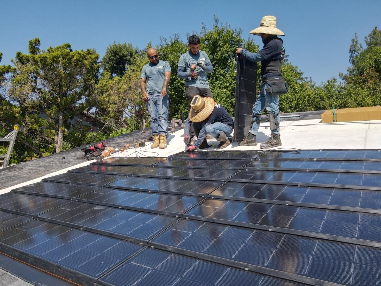 PBG install crew placing BIPV solar-integrated panels on a residential rooftop in Los Angeles.