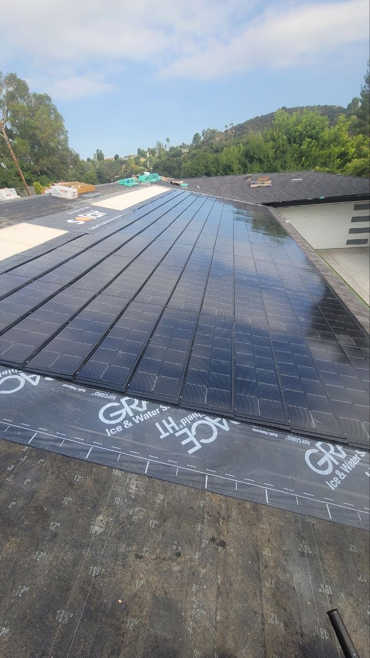 BIPV solar-integrated roof over premium Grace Ice & Water Shield underlayment on a two-story residential build — PBG, Los Angeles.
