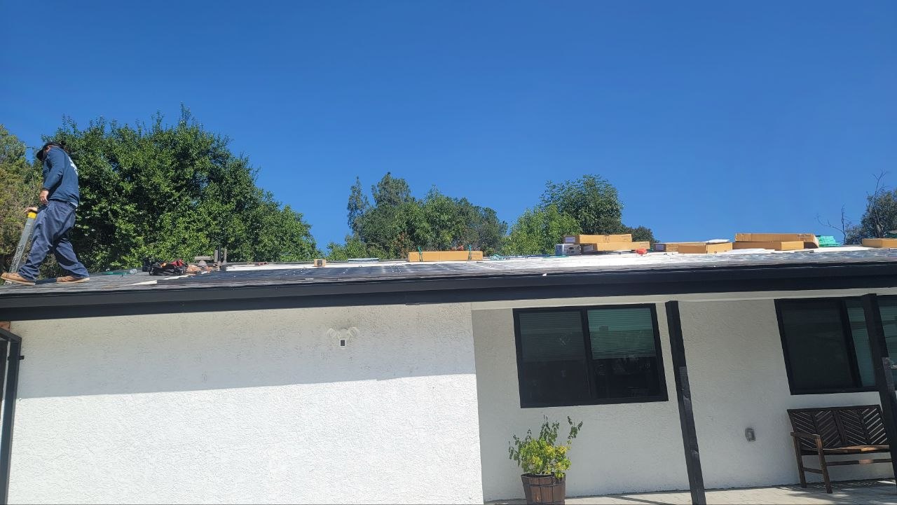 BIPV solar-integrated roof install in progress — wide view of the residential build with the PBG crew on the roof, Los Angeles.