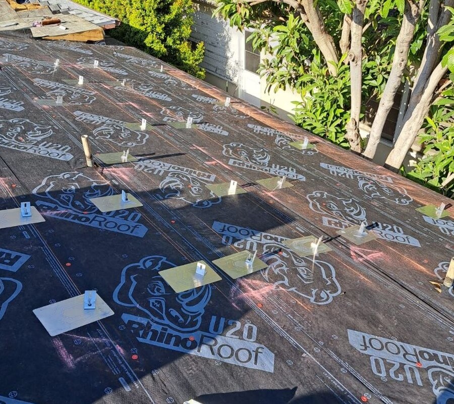 Solar-ready anchor pad layout set into RhinoRoof U20 underlayment before tile install — process detail from a PBG residential re-roof, Los Angeles.